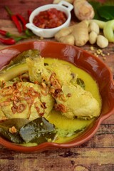 Opor ayam, chicken cooked in coconut milk from Indonesia, from Central Java, served with sambal. Popular dish for lebaran or Eid al-Fitr