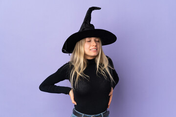 Young woman with witch costume over isolated background suffering from backache for having made an effort