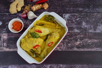 Opor ayam, chicken cooked in coconut milk and spices, originated from Central Java, Indonesia. Served with sambal. Popular dish for lebaran or Eid al-Fitr 