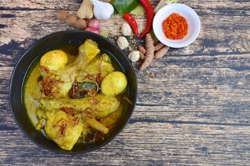 Opor ayam, chicken cooked in coconut milk from Indonesia, from Central Java, added with boiled eggs, served with sambal. Popular dish for lebaran or Eid al-Fitr