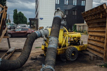 Cleaning sewer manholes by specialized pump machine on the street
