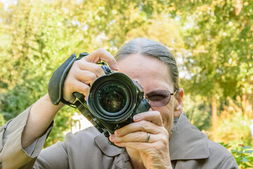 old woman photographer in the park