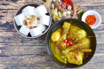 Opor ayam, chicken cooked in coconut milk from Indonesia, from Central Java, added with boiled eggs, served with lontong and sambal. Popular dish for lebaran or Eid al-Fitr