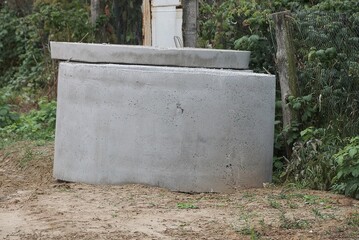 one gray concrete ring lie on the ground by the road