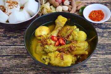 Opor ayam, chicken cooked in coconut milk from Indonesia, from Central Java, added with boiled eggs, served with lontong and sambal. Popular dish for lebaran or Eid al-Fitr