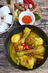 Opor ayam, chicken cooked in coconut milk from Indonesia, from Central Java, added with boiled eggs, served with lontong and sambal. Popular dish for lebaran or Eid al-Fitr