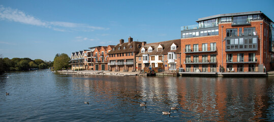 UK. 2020. Modern properties line the waterfront overlooking a river