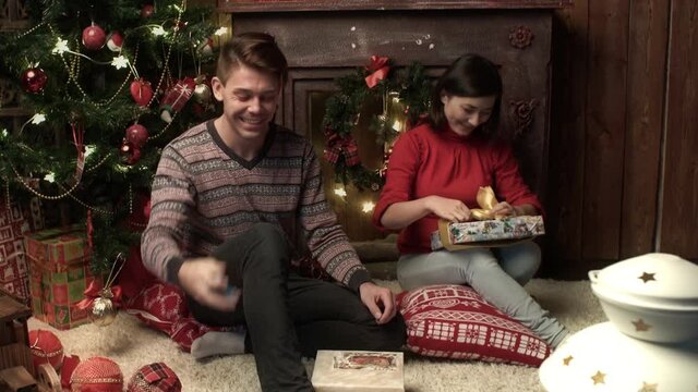 Family couple packing the presents at home. Relationship, family, christmas, new year, holiday concet.