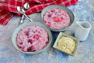Oatmeal porridge with blueberry, raspberries, blackberry, strawberry and red currants. Healthy diet breakfast