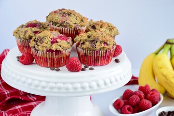 Raspberry banana chocolate chip muffins on cake stand