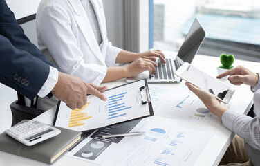 Three businessmen are brainstorming on how to manage the company's finances so that production...