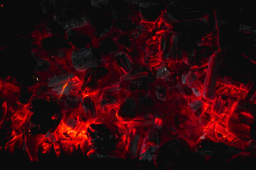 Fototapeta na wymiar hot red coals among black ash, wallpapers for mobile devices, abstract