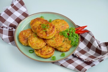 Perkedel, Indonesian fried potato minced beef patties garnish with parsley and chili in a bowl 