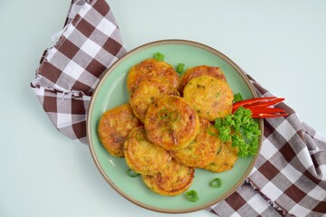 Perkedel, Indonesian fried potato minced beef patties garnish with parsley and chili in a bowl 