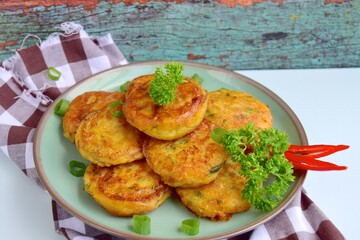 Perkedel, Indonesian fried potato minced beef patties garnish with parsley and chili in a bowl 