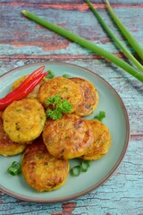 Perkedel, Indonesian fried potato minced beef patties garnish with parsley and chili in a bowl 