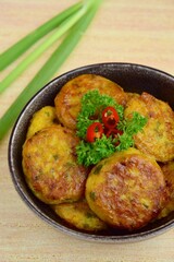 Perkedel, Indonesian fried potato minced beef patties garnish with parsley and chili in a bowl 
