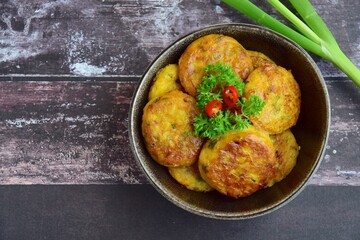 Perkedel, Indonesian fried potato minced beef patties garnish with parsley and chili in a bowl 