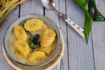Indonesian Cuisine - Kolak Pisang or Plantain Banana Compote. Cooked with coconut milk, palm sugar and pandanus leaves. Ramadhan menu.