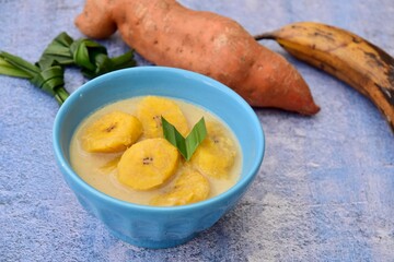 Indonesian traditional food Kolak Pisang. sweet plantain banana with coconut milk, palm sugar and pandan leaf
