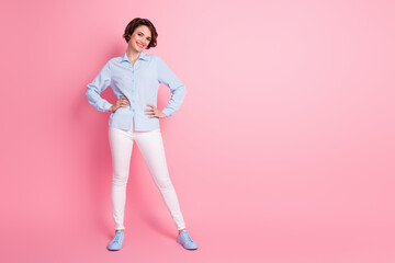 Fototapeta na wymiar Full length body size view of her she nice attractive lovely pretty glad content cheerful cheery skinny brown-haired girl hands on hips copy space isolated over pink pastel color background