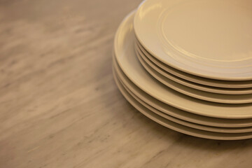 Stack of dishes on marble texture cooking desk