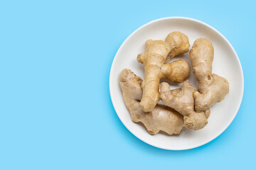 Ginger on white plate on blue background.