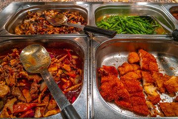 Different sets of Asian fast food in metal containers sold as street food, spicy fried chicken with vegetables and rice, details, closeup.
