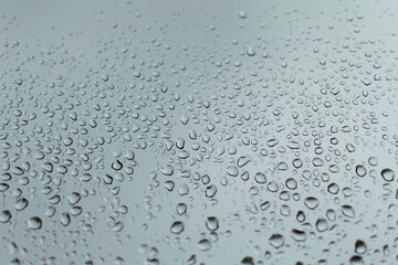 rain drops on a silver window during a thunder storm 