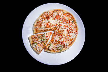 a single slice cut out from a full round cheese capsicum onion tomato flavor homemade pizza completely baked at home