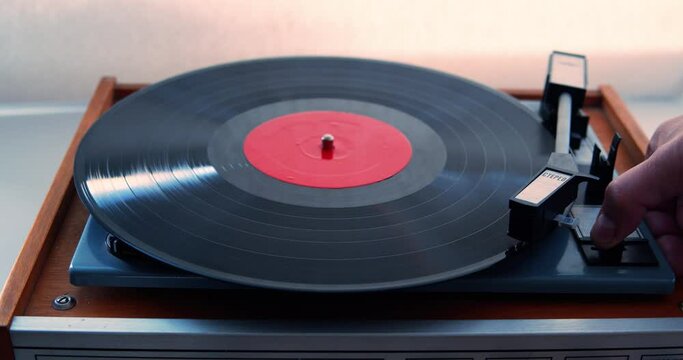 Man Turns on a Turntable With a Record