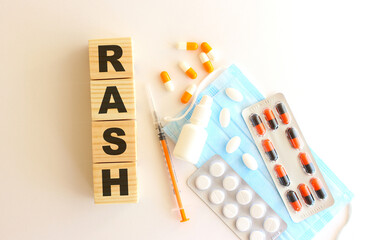 The word RASH is made of wooden cubes on a white background. Medical concept.