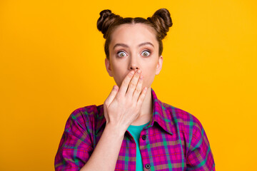 Close-up portrait of her she nice attractive afraid puzzled girl wearing checked shirt closing mouth oops don't speak conspiracy taboo isolated bright vivid shine vibrant yellow color background