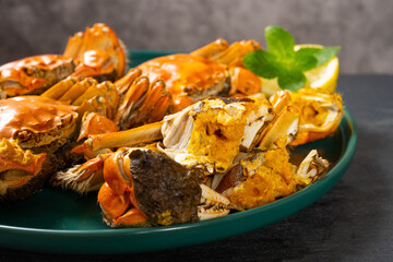 side view crabs with one opened showing the crab roe and meat horizontal composition