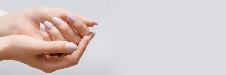 Gordijnen Female hands with rose nail design. Pink glitter nail polish manicure on white background, banner © devmarya