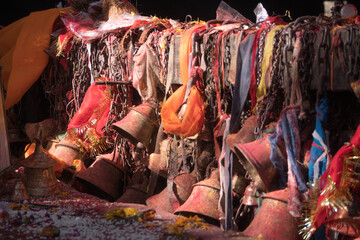 Hindu bells at door of temple tinted in orange tika.