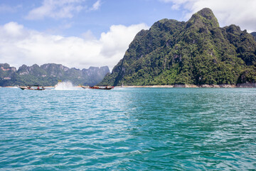 Obraz premium Beautiful mountains lake river sky and natural attractions in Ratchaprapha Dam at Khao Sok National Park, Surat Thani Province, Thailand.