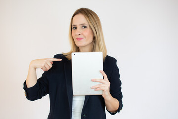 Joyful businesswoman holding a tablet in her hands and smiling