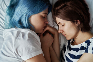 Fototapeta na wymiar Close up of lesbian couple sleeping on bed