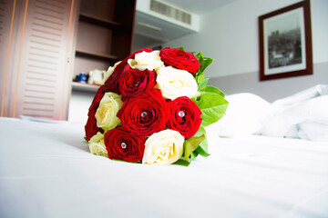 Red and White Roses Bouquet on a Bed 