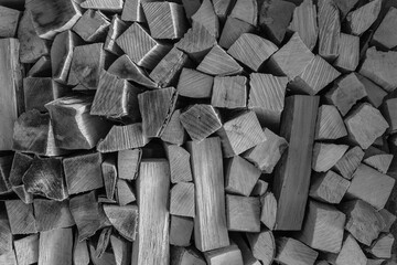 Stacked firewood, lots of wood for the fireplace, black and white photo