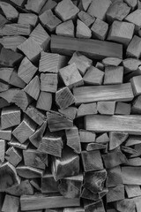 Stacked firewood, lots of wood for the fireplace, black and white photo