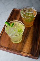 Cocktails. Traditional American drinks made by artisanal bartenders or mixologists in speakeasy & upscale bars or dives or taverns.Cocktails served in chilled cocktail glasses & garnished with fruit.