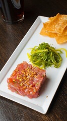 Tuna tartare. Classic American restaurant or bistro appetizer classic. Sushi grade ahi tuna, diced, mixed w/ eggs, red onions, olive oil, lemon juice, garlic & capers. Served w/ garlic bread.