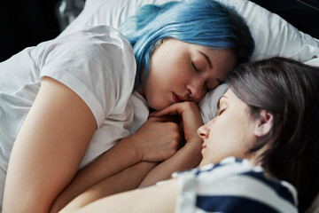 Close up of lesbian couple sleeping together in bed - Powered by Adobe