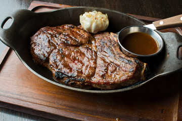 Steak. Grass-fed skirt steak, grilled to a medium rare and served with a garlic herb butter sauce and paired with roasted potatoes and Brussels sprouts. Classic American steakhouse favorite.