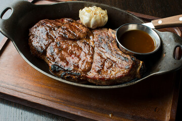 Steak. Grass-fed skirt steak, grilled to a medium rare and served with a garlic herb butter sauce and paired with roasted potatoes and Brussels sprouts. Classic American steakhouse favorite.