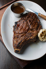 Steak. Grass-fed skirt steak, grilled to a medium rare and served with a garlic herb butter sauce and paired with roasted potatoes and Brussels sprouts. Classic American steakhouse favorite.