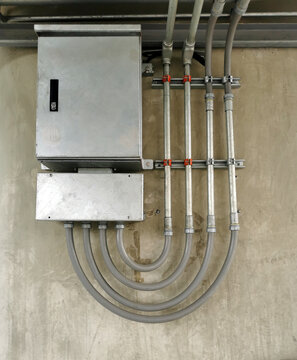 electric power supply unit with industrial steel pipes or cable conduit.