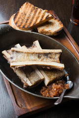 Bone Marrow. Grass-fed skirt steak, grilled to a medium rare and served with a garlic herb butter sauce and paired with roasted potatoes and Brussels sprouts. Classic American steakhouse favorite.